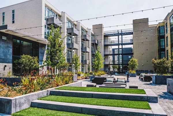 Cozy patio with modern furnishings at Aquatic I Apartments, perfect for outdoor relaxation in a luxury setting