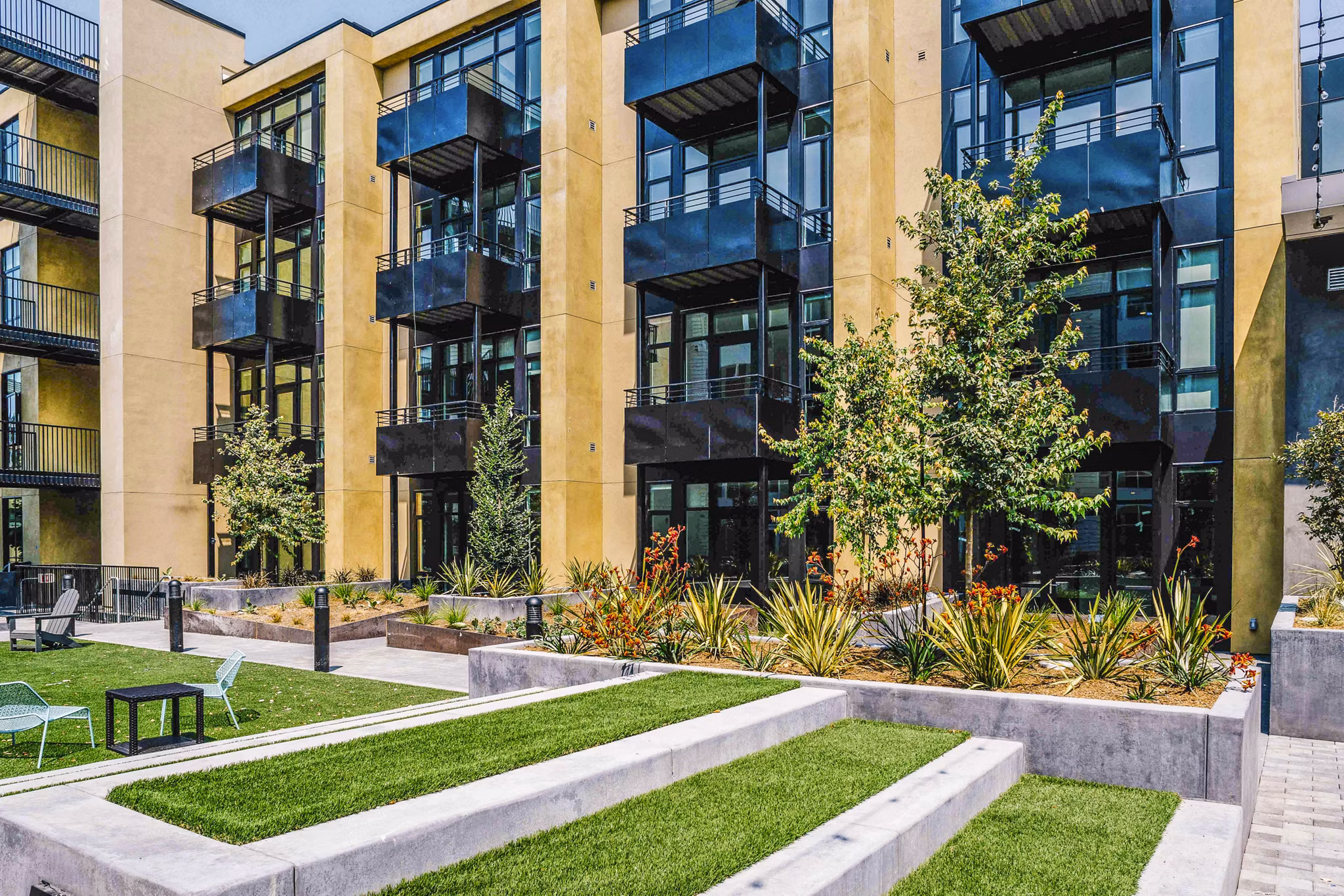 Aquatic I Apartments: Serene courtyard with lush landscaping at luxury apartments in a tranquil setting