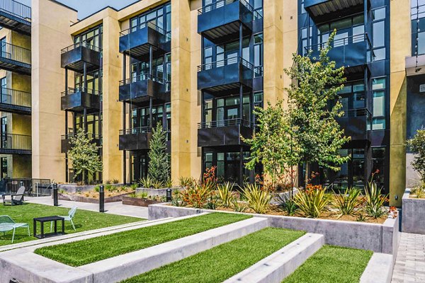 Aquatic I Apartments: Serene courtyard with lush landscaping at luxury apartments in a tranquil setting