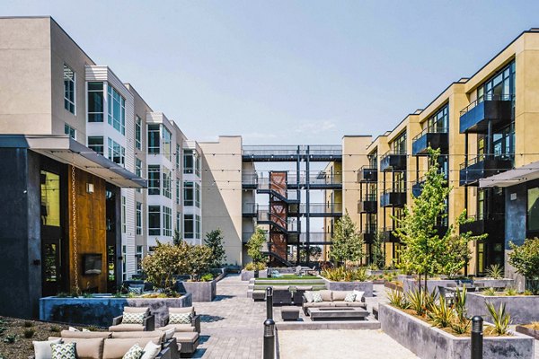 Aquatic I Apartments: Lush landscaped courtyard with seating and greenery