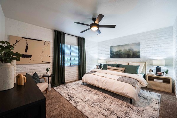 Bedroom with modern furnishings and natural light at La Privada Apartments