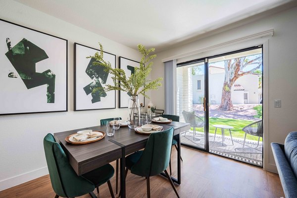 Dining area with elegant seating and modern lighting at La Privada Apartments