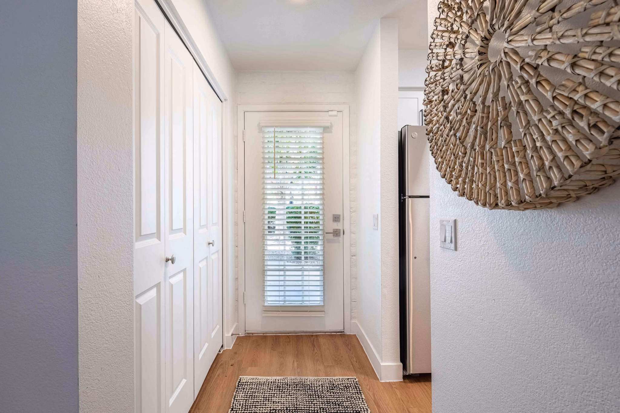 Bright hallway with modern lighting fixtures at La Privada Apartments, offering luxury living in a Greystar community