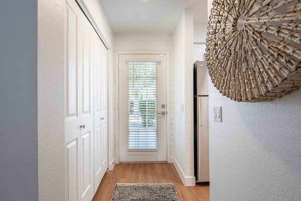 Bright hallway with modern lighting fixtures at La Privada Apartments, offering luxury living in a Greystar community
