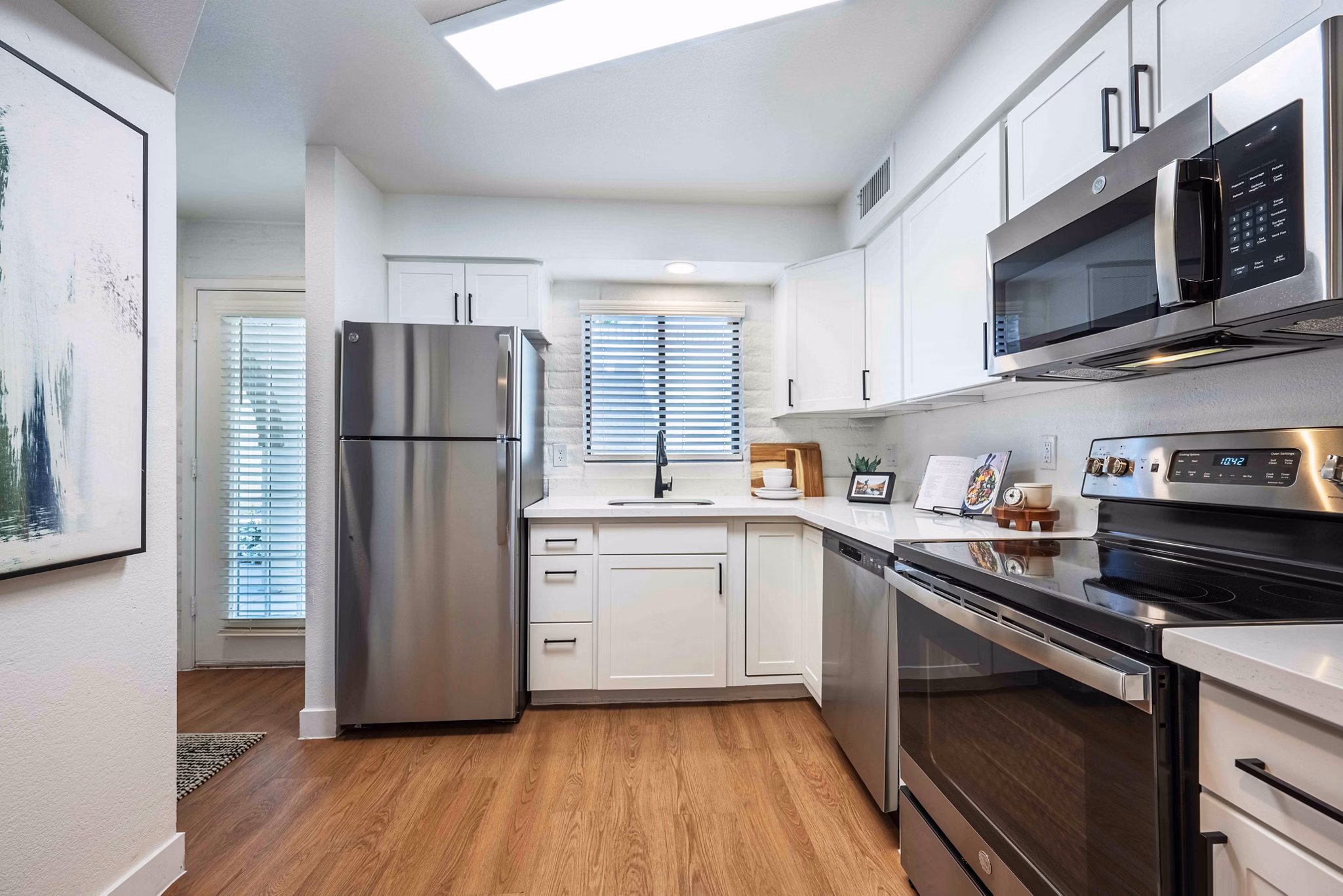 Modern kitchen with sleek countertops and stainless steel appliances in La Privada Apartments