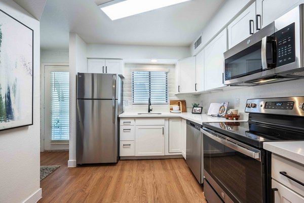 Modern kitchen with sleek countertops and stainless steel appliances in La Privada Apartments