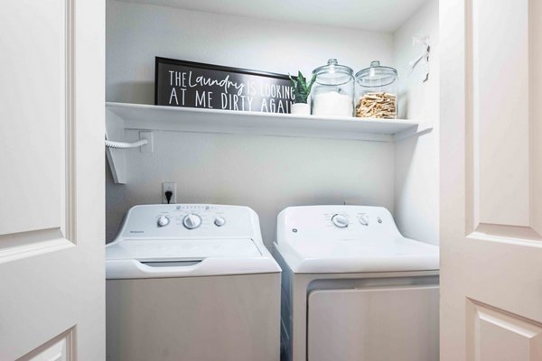 Modern laundry room with high-efficiency washers and dryers at La Privada Apartments