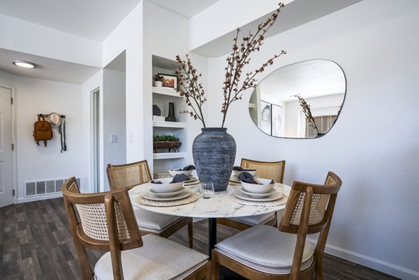 Dining room with modern furnishings and elegant lighting in The Aubry Apartments at Greystar