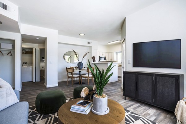 Modern living room with stylish furnishings and large windows at The Aubry Apartments