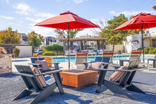 Outdoor fire pit and pool patio at The Aubry Apartments offering luxury amenities near Greystar properties