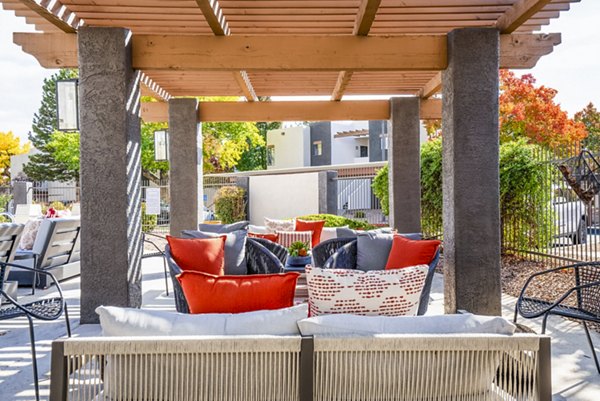 Pool patio with modern lounge chairs at The Aubry Apartments, a luxury residence offering upscale amenities