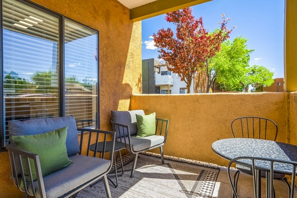 Private patio with modern furniture overlooking scenic views at The Aubry Apartments