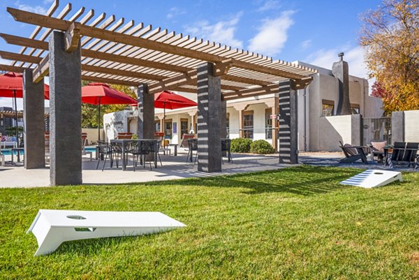 Outdoor recreational area with greenery and seating at The Aubry Apartments