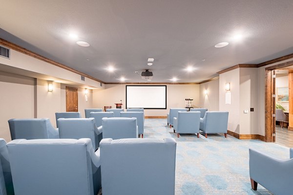 Theater room with plush seating at Larkspur at Twin Creeks Apartments, offering luxury movie experience