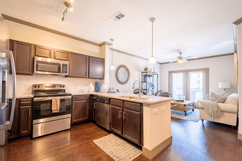 Modern kitchen with sleek countertops and stainless-steel appliances at Larkspur at Twin Creeks Apartments
