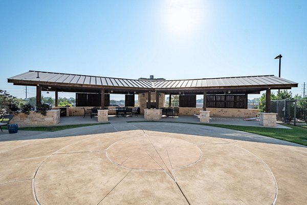 Courtyard featuring lush landscaping and seating areas at Larkspur at Twin Creeks Apartments