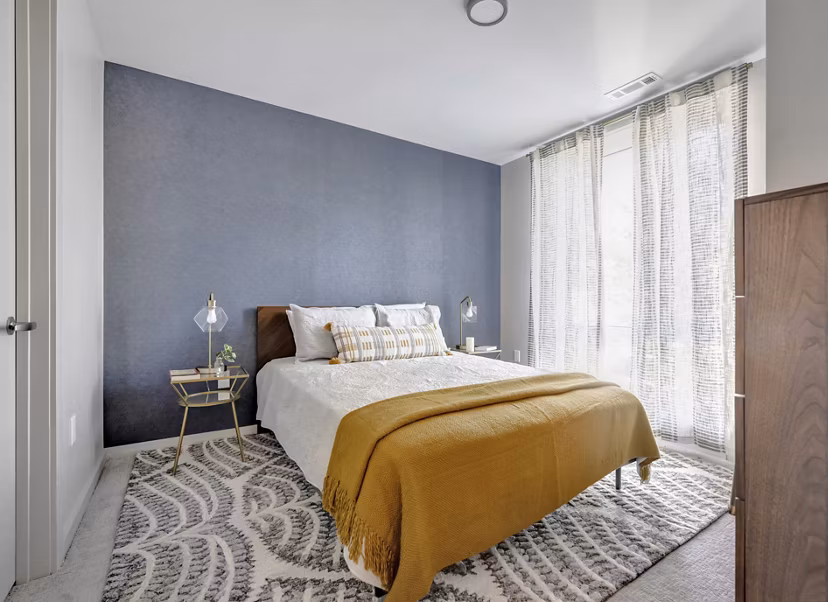 Cozy bedroom with elegant furnishings at 1550 on the Charles Apartments in Cambridge