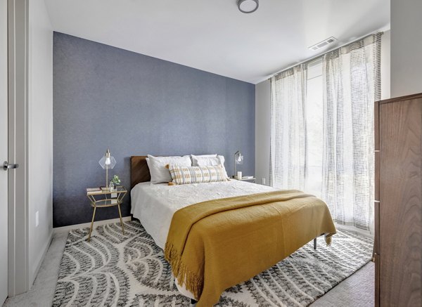 Cozy bedroom with elegant furnishings at 1550 on the Charles Apartments in Cambridge