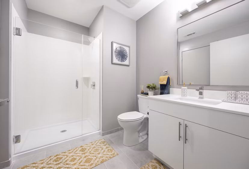 Modern bathroom featuring sleek fixtures and marble countertops at 1550 on the Charles Apartments