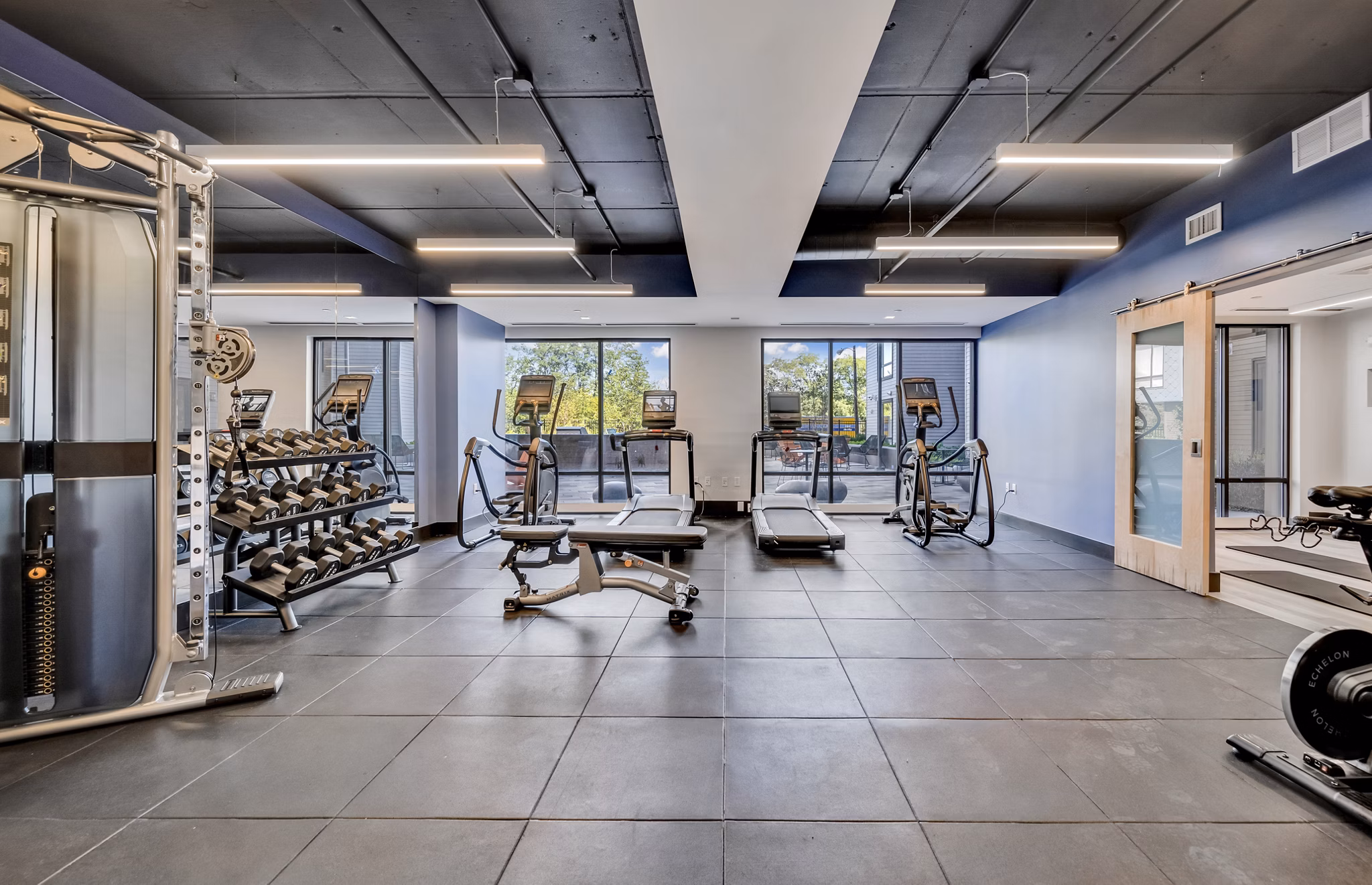 State-of-the-art fitness center at 1550 on the Charles Apartments with modern equipment and spacious workout areas