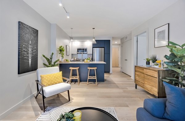 Living room featuring modern decor and ample natural light at 1550 on the Charles Apartments