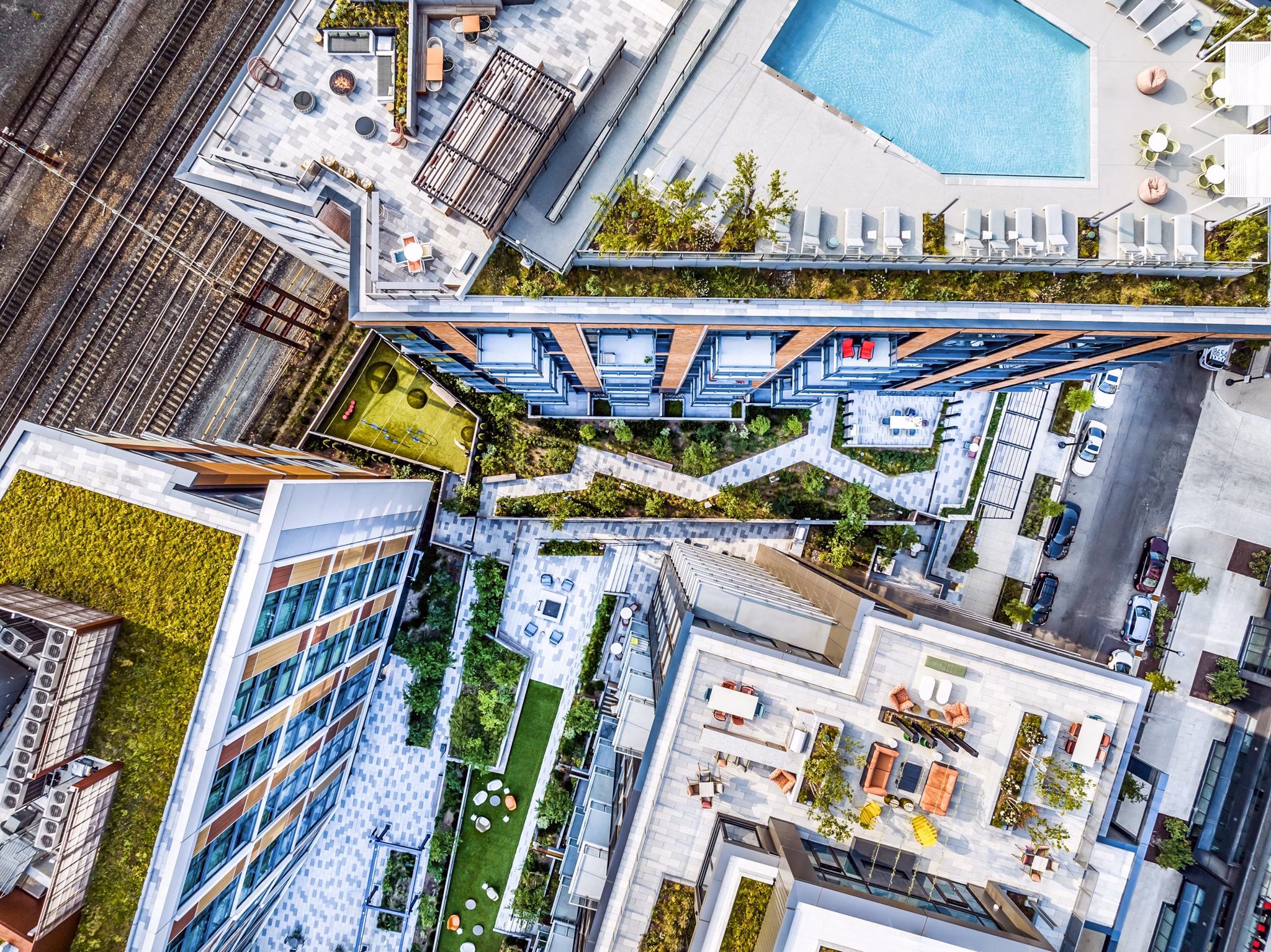 â€œRefreshing swimming pool area with red Adirondack chairs near luxury apartmentsâ€