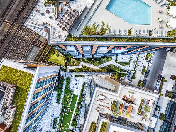 â€œRefreshing swimming pool area with red Adirondack chairs near luxury apartmentsâ€