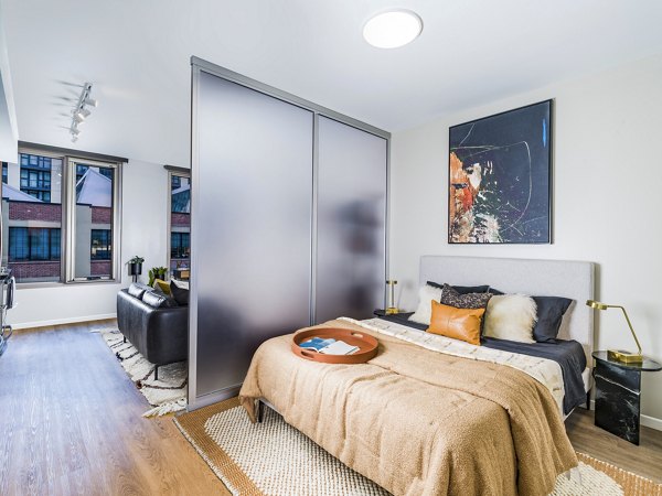 Cozy bedroom with designer furnishings at Market House Apartments