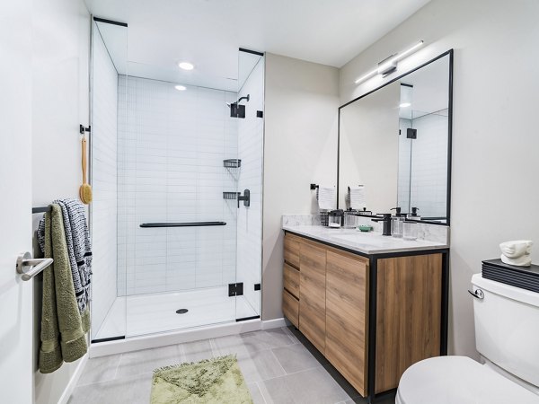 Bathroom with marble countertops and dual sinks in Market House Apartments