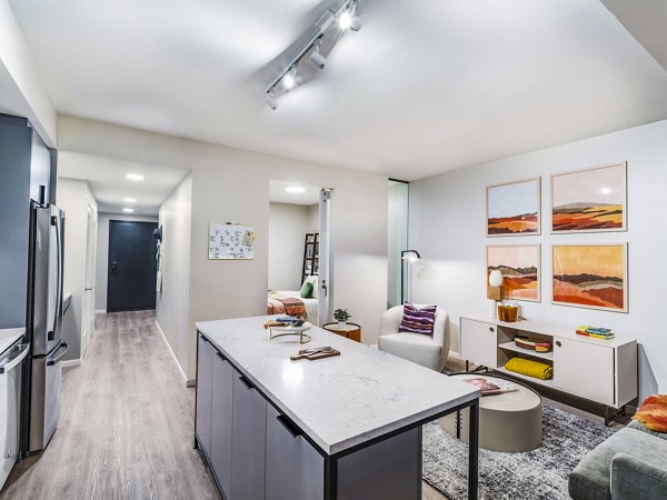 Kitchen featuring modern appliances and granite countertops at Market House Apartments