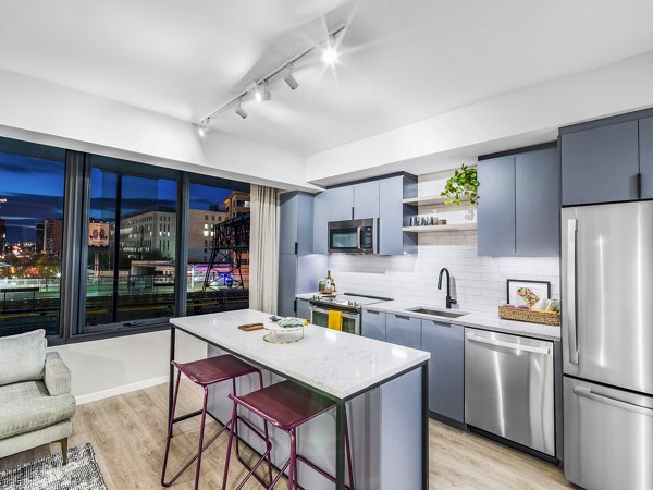 Market House Apartments: Modern kitchen with sleek cabinetry and stainless steel appliances