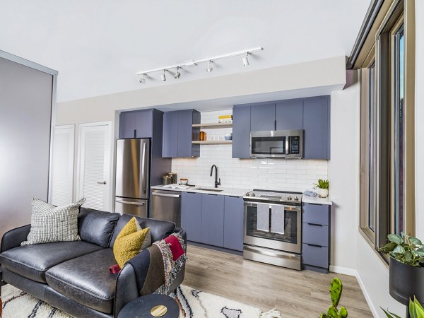 Modern kitchen with stainless steel appliances at Market House Apartments, luxury living in a Greystar community