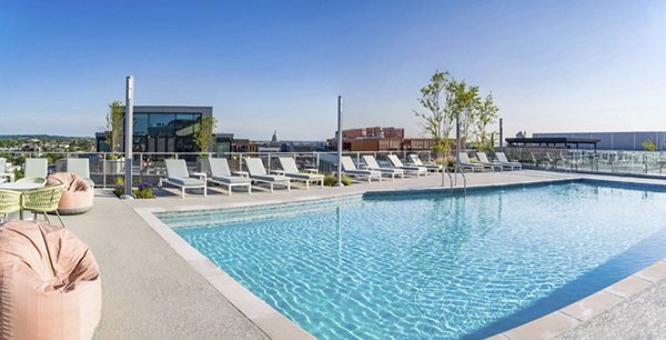 Modern outdoor pool with sun loungers at Market House Apartments, a Greystar luxury community