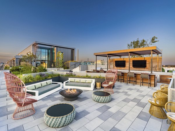 Modern fire pit at Market House Apartments offers cozy outdoor seating and relaxation