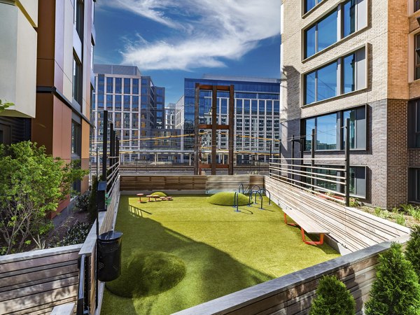 Dog park at Market House Apartments with agility equipment and open play area, providing pet-friendly luxury living near Greystar's Market House community