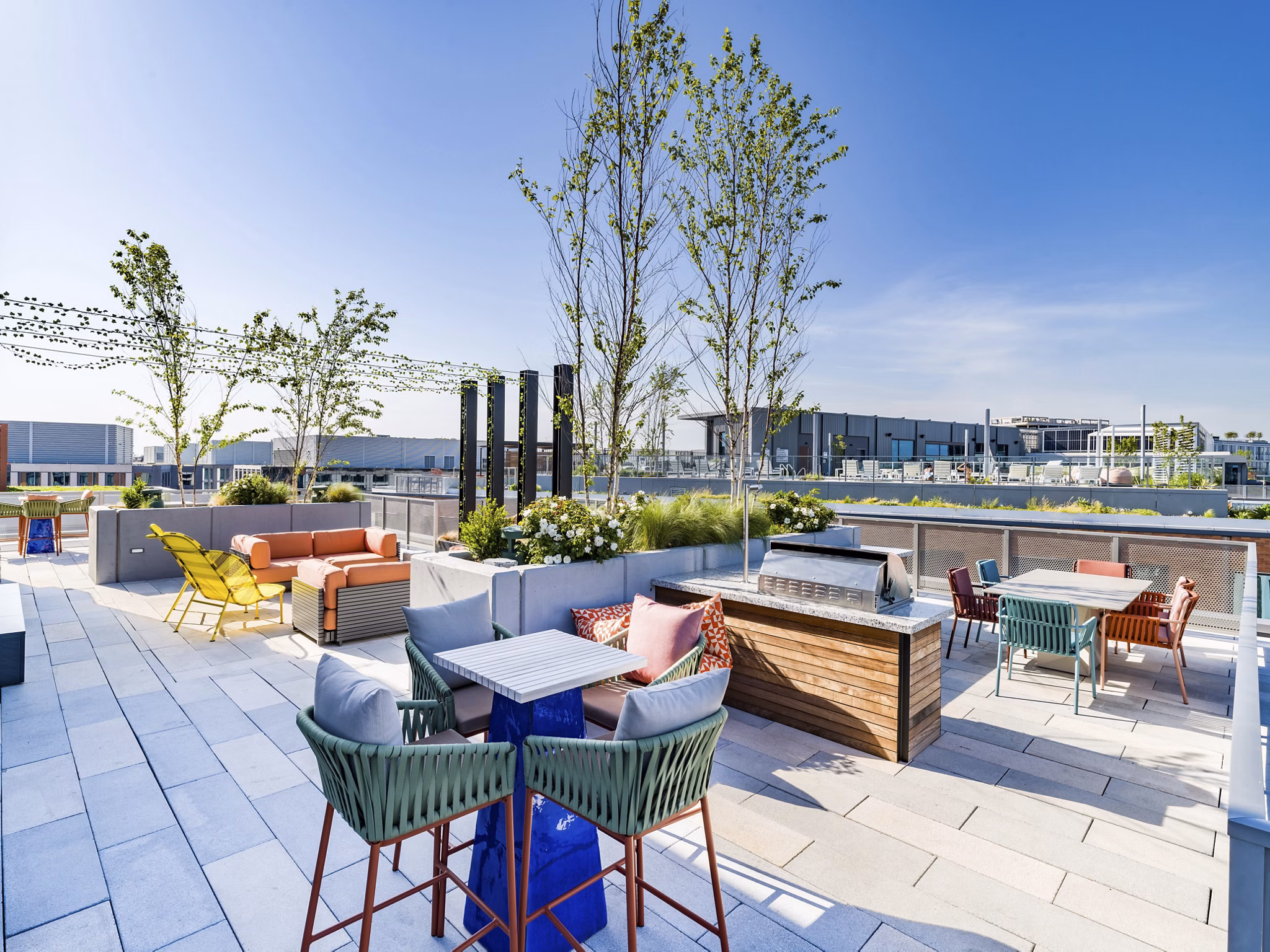 Rooftop deck with modern seating and city skyline views at Market House Apartments