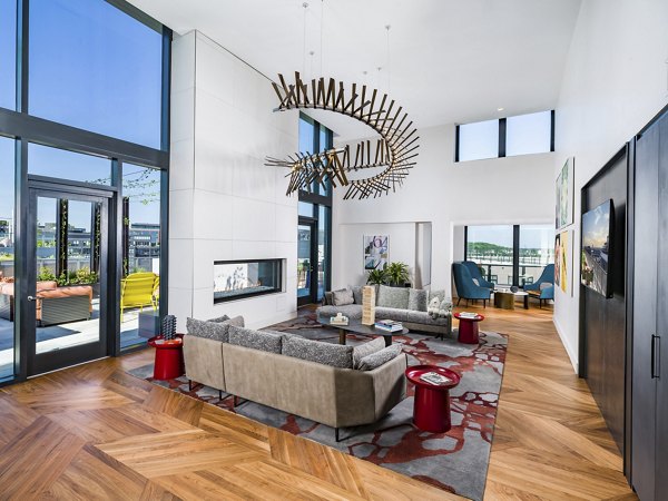 Modern clubhouse featuring cozy seating and vibrant decor at Rigby Apartments