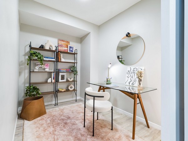 Home office with modern desk and ergonomic chair at Rigby Apartments