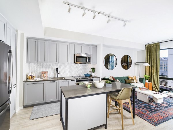 Modern kitchen with stainless steel appliances at Rigby Apartments, a luxury living option by Greystar