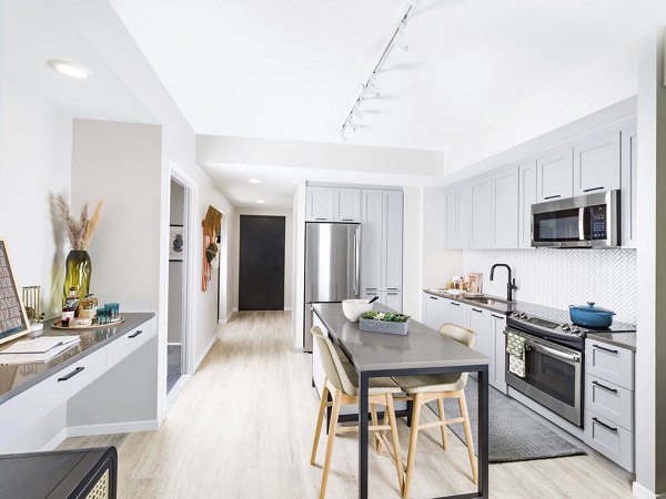 Modern kitchen with stainless steel appliances at Rigby Apartments