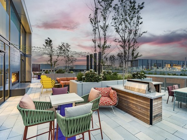 Outdoor grilling area with modern facilities at Rigby Apartments, a luxurious living space for community gatherings and dining
