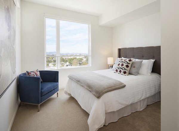 Modern bedroom featuring elegant decor and spacious layout at Eastway Apartments