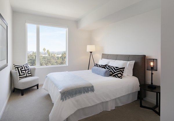 Cozy bedroom featuring modern decor and ample natural light at Eastway Apartments