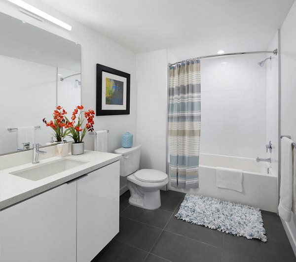 Stylish bathroom with modern fixtures at Eastway Apartments featuring luxury finishes and spacious design