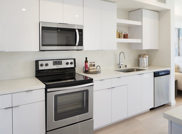 Contemporary kitchen with stainless steel appliances at Eastway Apartments