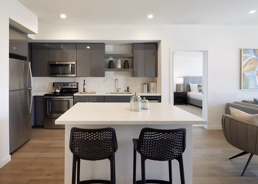 Modern kitchen featuring stainless steel appliances and quartz countertops at Eastway Apartments