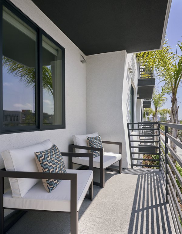 Expansive patio with outdoor seating at Eastway Apartments, perfect for relaxation and gatherings in a serene setting