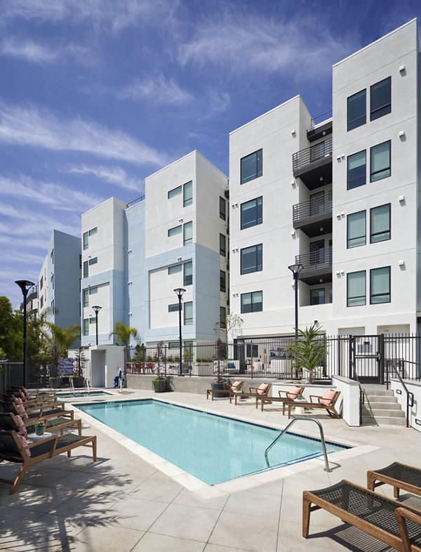 Resort-style pool with lounge chairs at Eastway Apartments offering luxury leisure