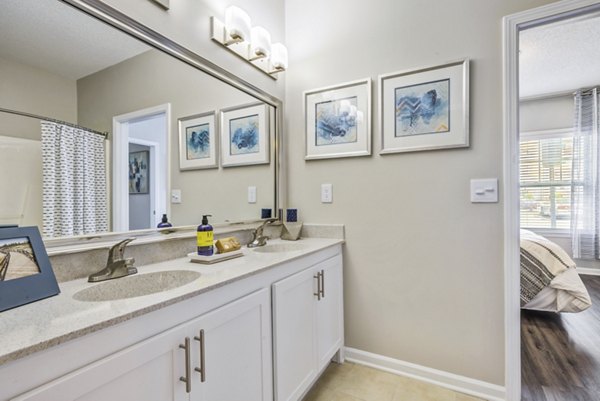 Modern bathroom with sleek fixtures and ample lighting at Avant at Steele Creek luxury apartments
