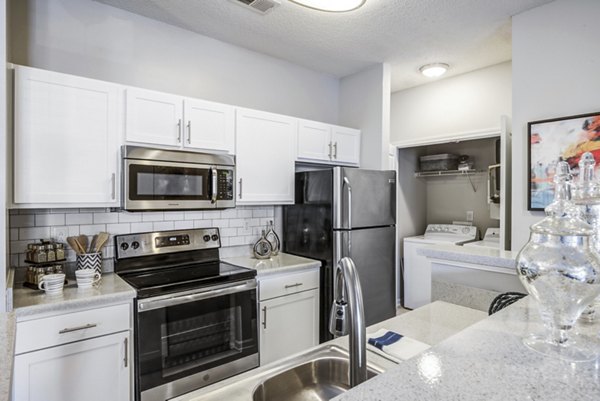 Modern kitchen featuring sleek countertops and stainless steel appliances at Avant at Steele Creek Luxury Apartments